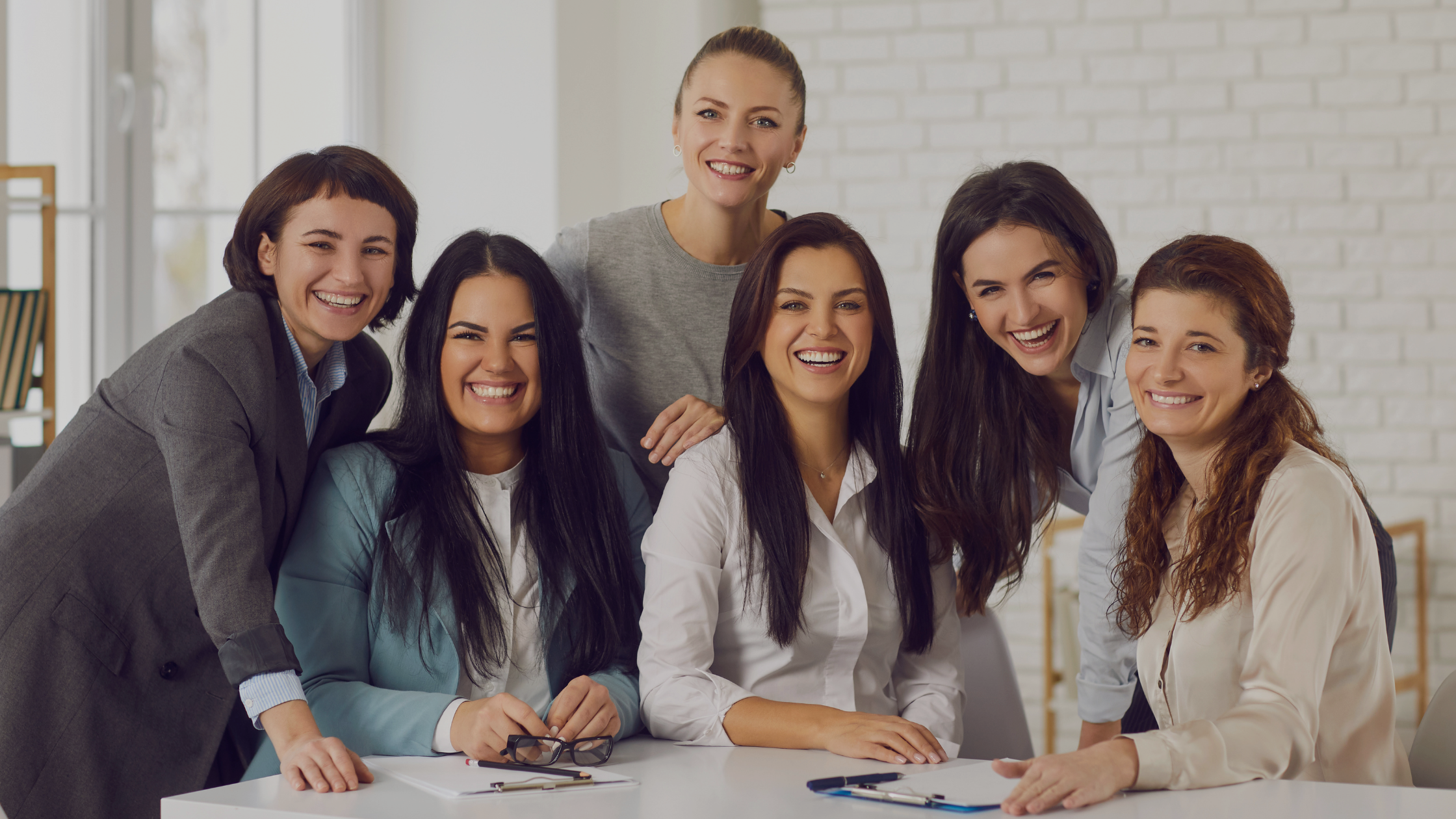 Group of professional women together in a modern workspace